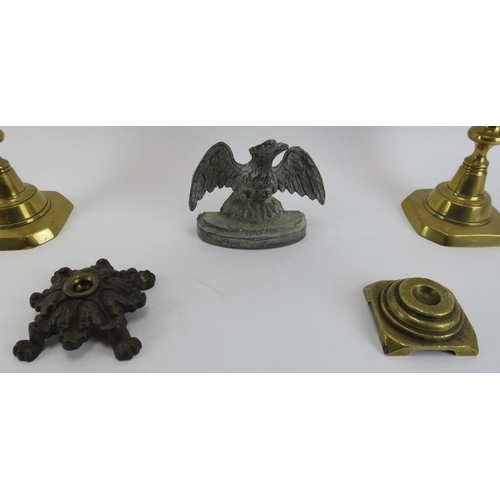 172 - A pair of late Victorian brass candlesticks, two Victorian fire iron rests and a cast lead eagle doo... 