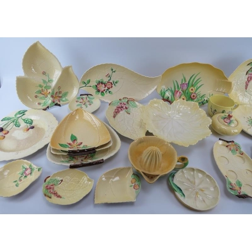 177 - A large group of Carlton Ware porcelain wares. A variety of patterns decorated against a yellow grou... 