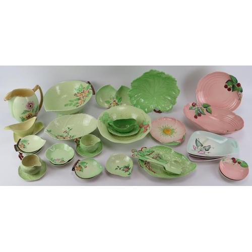 179 - A large group of Carlton Ware porcelain wares. A variety of patterns decorated against green, pink a... 