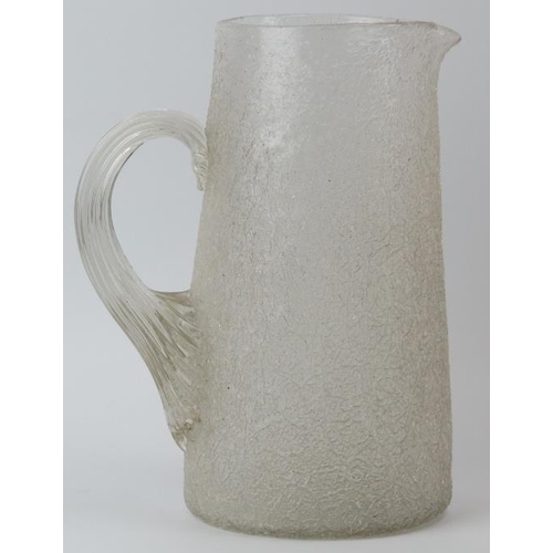 180 - A large cracked ice glass jug, late 19th/early 20th century. Modelled with a reeded loop handle. 25.... 