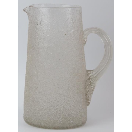 180 - A large cracked ice glass jug, late 19th/early 20th century. Modelled with a reeded loop handle. 25.... 