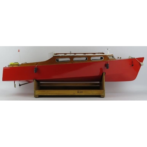 199 - Toys and Models: An RC pleasure cruiser model boat. With a painted red hull and varnished decking. R... 