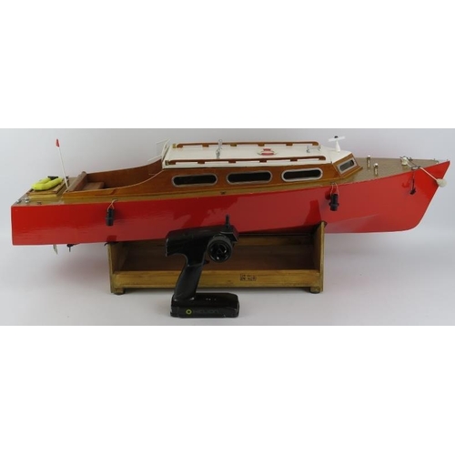 199 - Toys and Models: An RC pleasure cruiser model boat. With a painted red hull and varnished decking. R... 