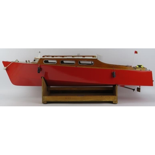 199 - Toys and Models: An RC pleasure cruiser model boat. With a painted red hull and varnished decking. R... 