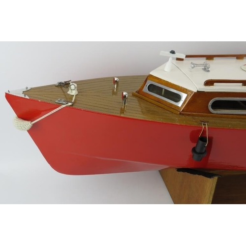 199 - Toys and Models: An RC pleasure cruiser model boat. With a painted red hull and varnished decking. R... 