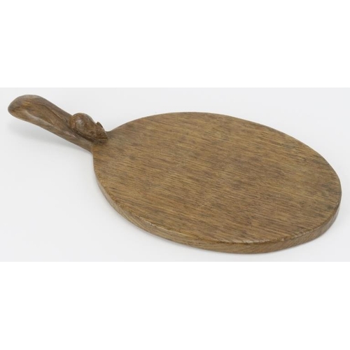 21 - A Robert ‘Mouseman’ Thompson English oak cheeseboard. Of oval form with the trademark mouse carved i... 