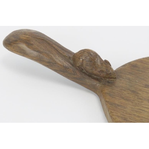 21 - A Robert ‘Mouseman’ Thompson English oak cheeseboard. Of oval form with the trademark mouse carved i... 