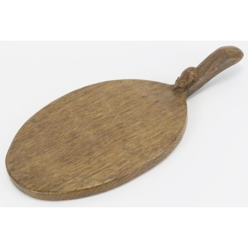 21 - A Robert ‘Mouseman’ Thompson English oak cheeseboard. Of oval form with the trademark mouse carved i... 