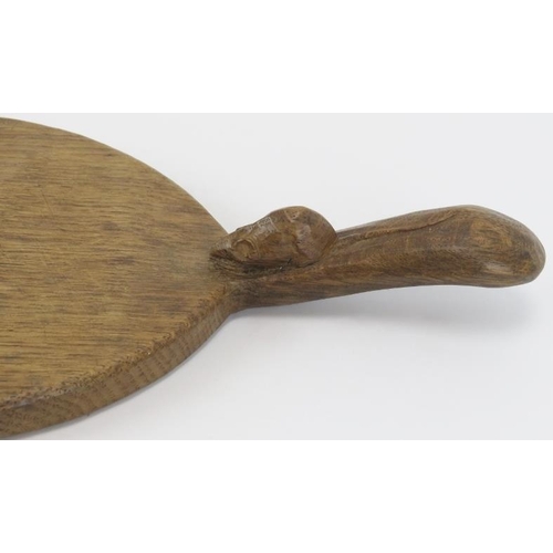 21 - A Robert ‘Mouseman’ Thompson English oak cheeseboard. Of oval form with the trademark mouse carved i... 