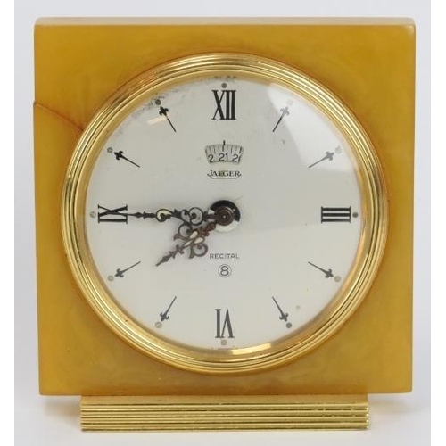 22 - A vintage Jaeger LeCoultre eight day recital alarm travel clock. With an amber coloured bakelite squ... 