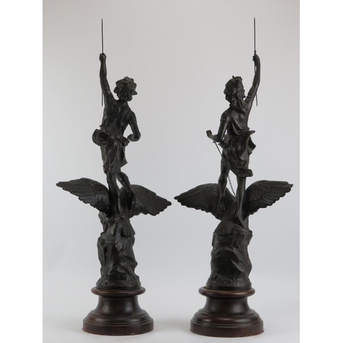 238 - A large pair of bronzed spelter figures, 20th century. Modelled depicting a male and female holding ... 