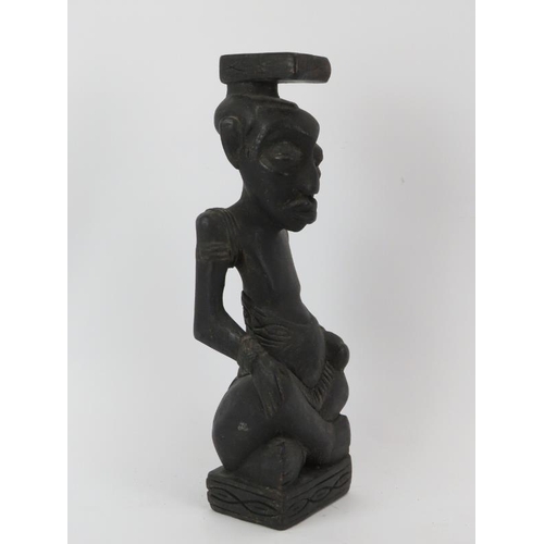 257 - Tribal Art: An African carved and ebonised wood seated figure, Congo. 35 cm height. Condition report... 