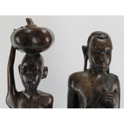 264I - Two large East African carved hardwood male and female figures. 70 cm height, 73 cm height. 

Condit... 