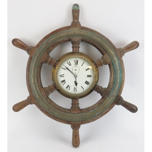 27 - Maritime: A Sestrel bulkhead clock set within an oak and brass six spoke ship’s wheel, 20th century.... 