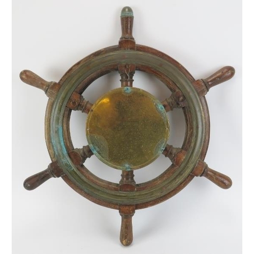 27 - Maritime: A Sestrel bulkhead clock set within an oak and brass six spoke ship’s wheel, 20th century.... 