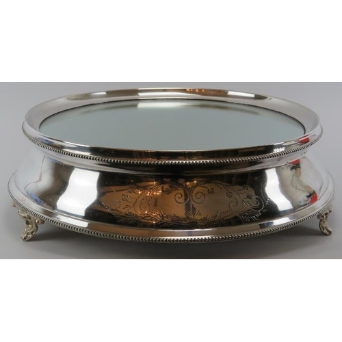 297 - A large silver plated cake stand and cake knife. Cake stand with a glass top, supported on three spl... 