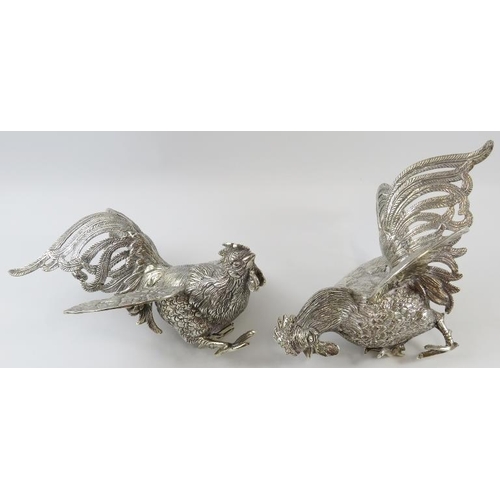 325 - A pair of Middle Eastern white metal fighting cockerel figures, each bearing a .900 mark in Arabic. ... 