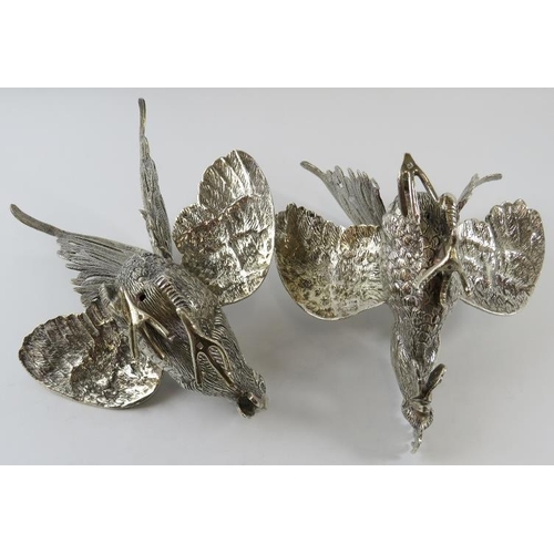 325 - A pair of Middle Eastern white metal fighting cockerel figures, each bearing a .900 mark in Arabic. ... 