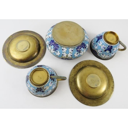 328 - Two Russian silver gilt and enamel cups and saucers and a matching sugar basket.  Each with enamelle... 