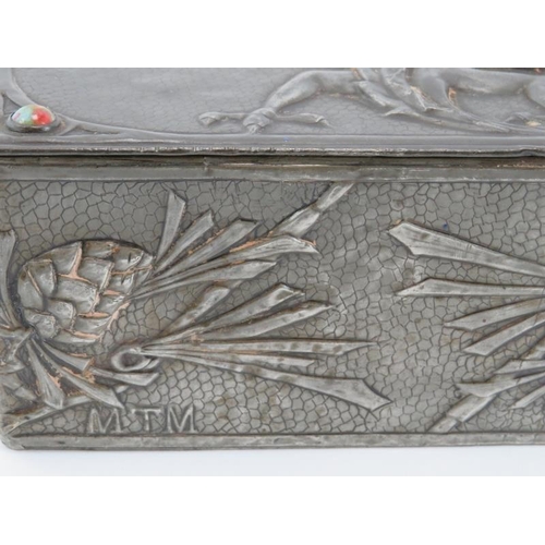 56 - A rare Arts & Crafts pewter trinket box, early 20th century. Decorated in repoussé with a dragon and... 