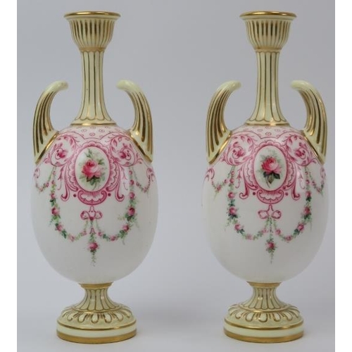 87 - A pair of Royal Worcester twin handled gilt porcelain vases, circa 1900. Both of ovoid form, hand pa... 