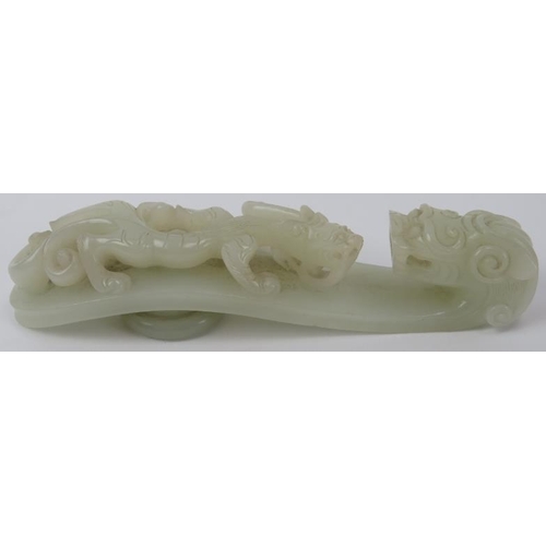 89 - A Chinese celadon jade dragon belt hook, 18th/19th century. Finely carved depicting a chilong dragon... 