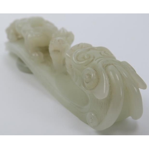 89 - A Chinese celadon jade dragon belt hook, 18th/19th century. Finely carved depicting a chilong dragon... 