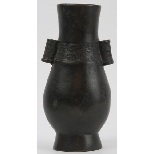 90 - A Chinese bronze twin handled arrow vase, Qing dynasty. Of pear shaped form, cast with hollow tubula... 