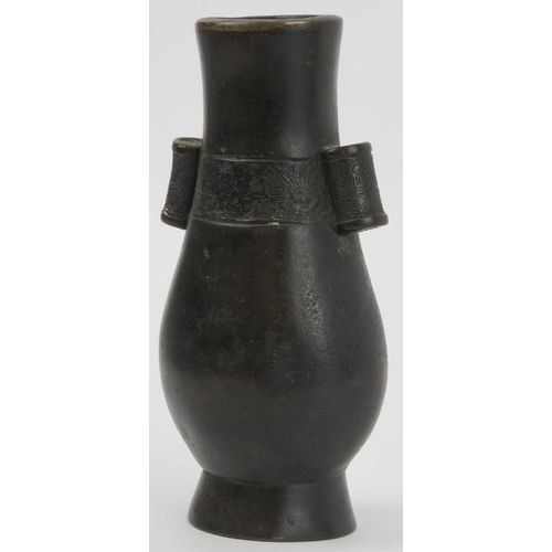 90 - A Chinese bronze twin handled arrow vase, Qing dynasty. Of pear shaped form, cast with hollow tubula... 