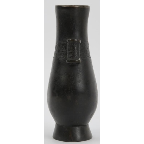 90 - A Chinese bronze twin handled arrow vase, Qing dynasty. Of pear shaped form, cast with hollow tubula... 