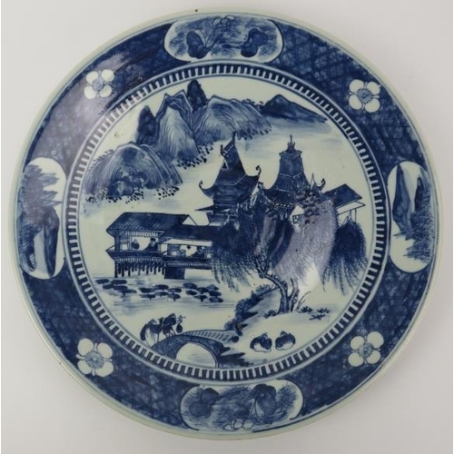 96 - A Chinese blue and white porcelain charger, 19th century. Painted depicting a lakeside pavilion with... 