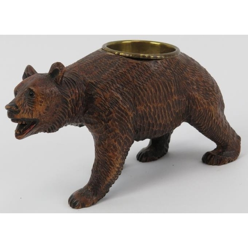 99 - A Black Forest carved wood bear with brass bowl. Modelled with glass eyes. Possibly to be utilised a... 