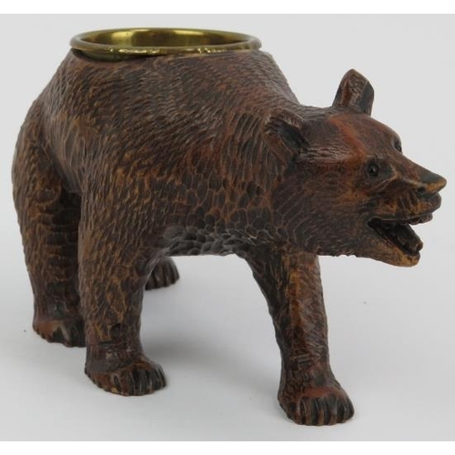 99 - A Black Forest carved wood bear with brass bowl. Modelled with glass eyes. Possibly to be utilised a... 