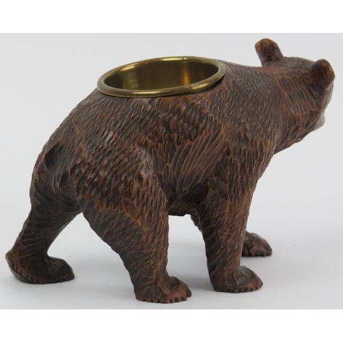 99 - A Black Forest carved wood bear with brass bowl. Modelled with glass eyes. Possibly to be utilised a... 