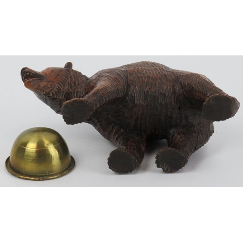 99 - A Black Forest carved wood bear with brass bowl. Modelled with glass eyes. Possibly to be utilised a... 