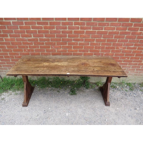 702 - A 19th century Arts & Crafts oak refectory table, the roughly hewn planked top on braced end support... 