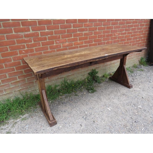 702 - A 19th century Arts & Crafts oak refectory table, the roughly hewn planked top on braced end support... 