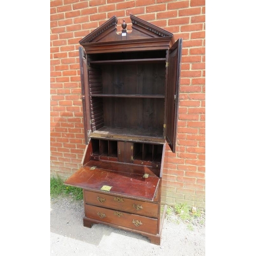 703 - An 18th century mahogany bureau bookcase, the broken pediment with turned centre finial and dentil c... 