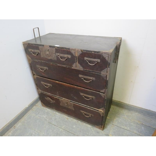 705 - An antique Japanese Meiji Period ebonised metal bound tansu chest, housing two short above three lon... 