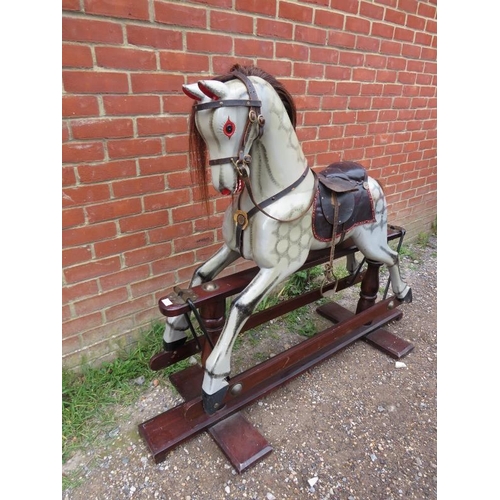 706 - A vintage dapple-grey rocking horse, with real horsehair mane and tail and leather saddle and tack, ... 