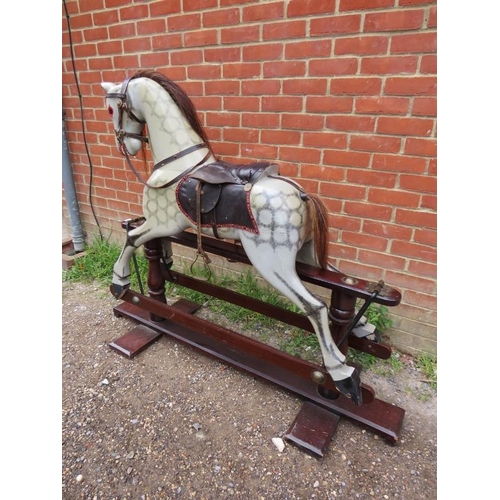 706 - A vintage dapple-grey rocking horse, with real horsehair mane and tail and leather saddle and tack, ... 