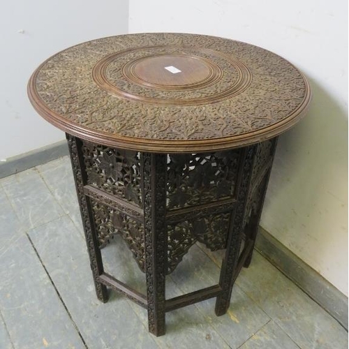 709 - An early 20th century Angle Indian hardwood occasional table, the circular top with relief carving d... 