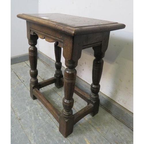 712 - An antique oak joint stool in the 17th century taste with shaped frieze, on turned supports with blo... 