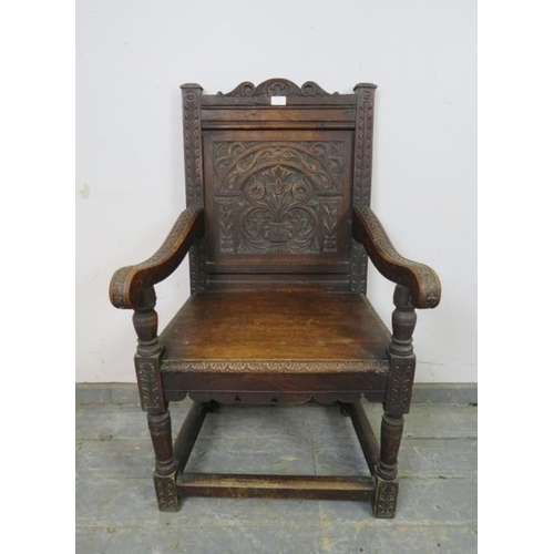 715 - A 19th century oak Wainscott chair in the 17th century taste, the backrest profusely carved with aca... 