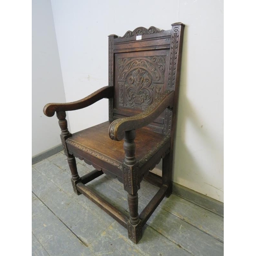 715 - A 19th century oak Wainscott chair in the 17th century taste, the backrest profusely carved with aca... 