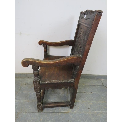 715 - A 19th century oak Wainscott chair in the 17th century taste, the backrest profusely carved with aca... 