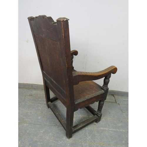 715 - A 19th century oak Wainscott chair in the 17th century taste, the backrest profusely carved with aca... 