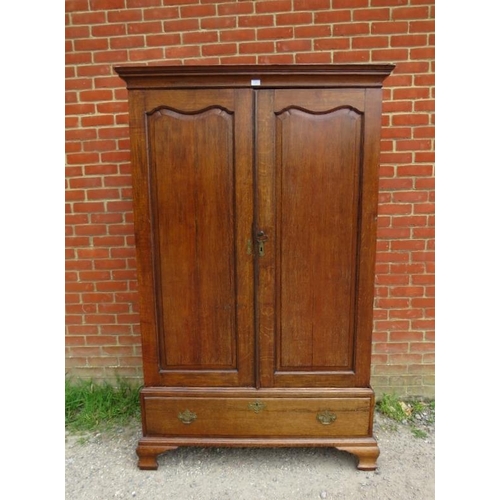 716 - An 18th century Continental oak linen press/wardrobe, having fielded front and side panels, the doub... 