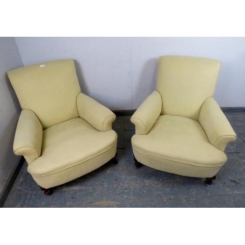 720 - A pair of 19th century club armchairs in the manner of Howard & sons, reupholstered in pale yellow m... 