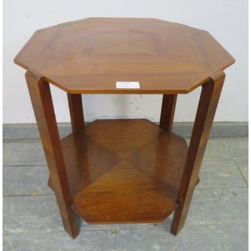 720A - An Art Deco Period walnut octagonal two-tier table, the quarter veneered top with swing-out brass as... 